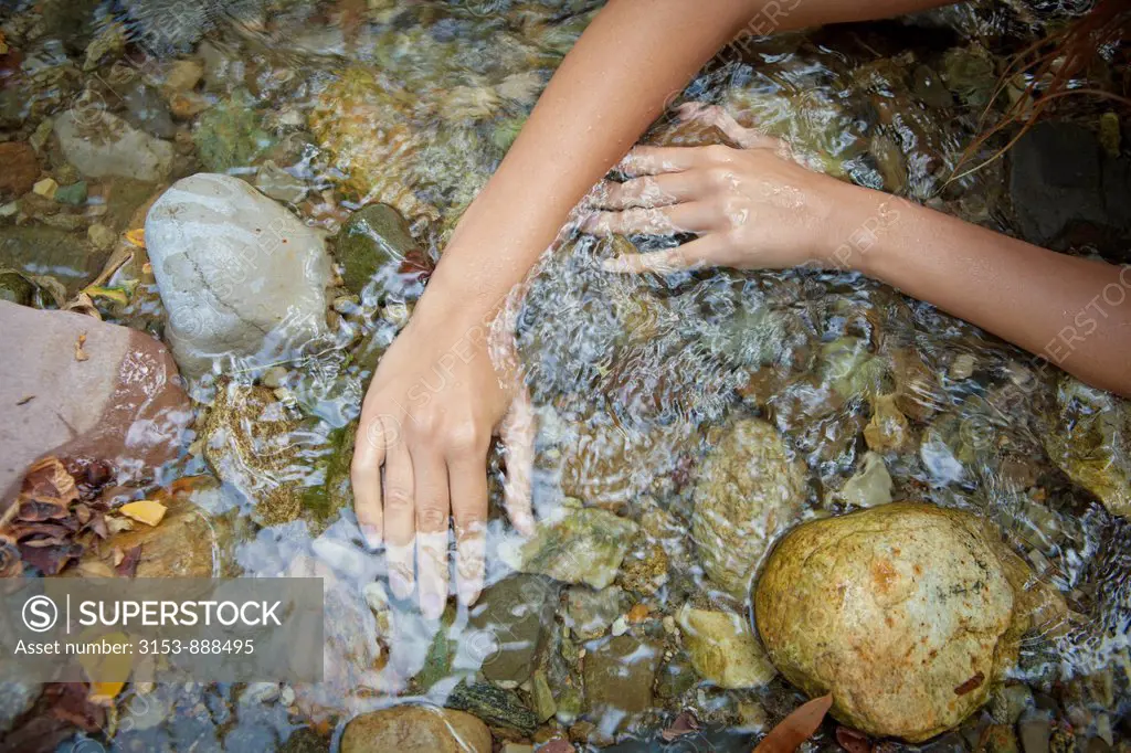 woman's hands in a stream