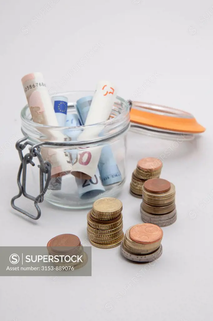 coins and jar with banknotes