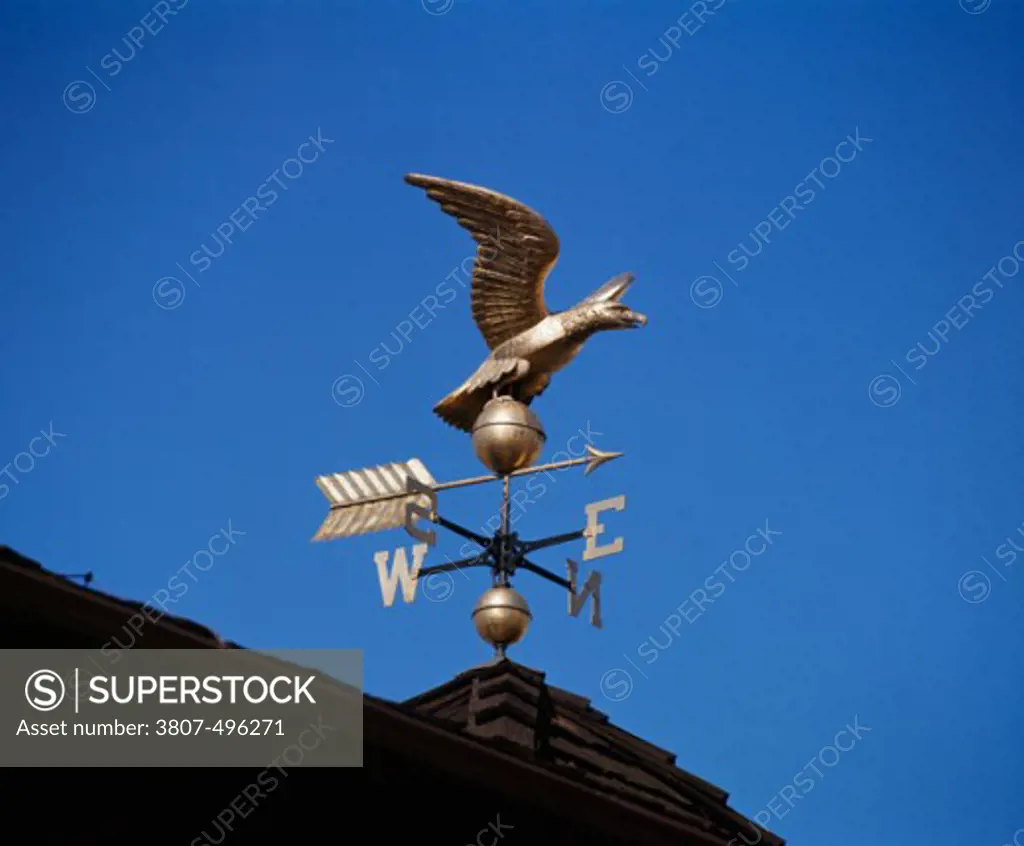 Low angle view of a weather vane on the roof of a building