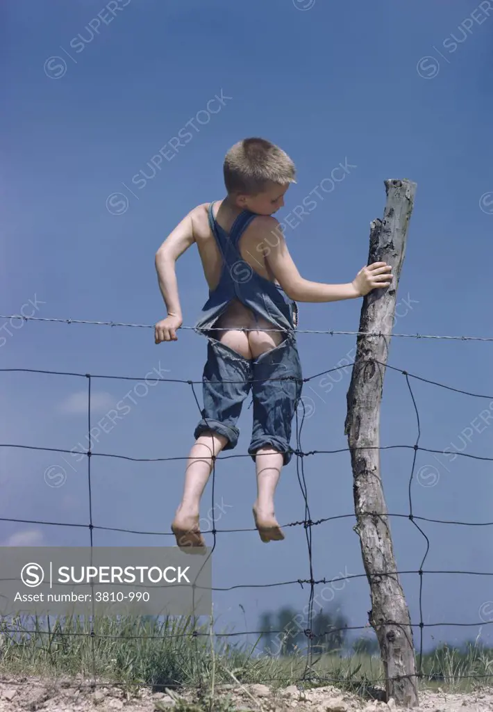 Boy trapped in a barbed wire fence