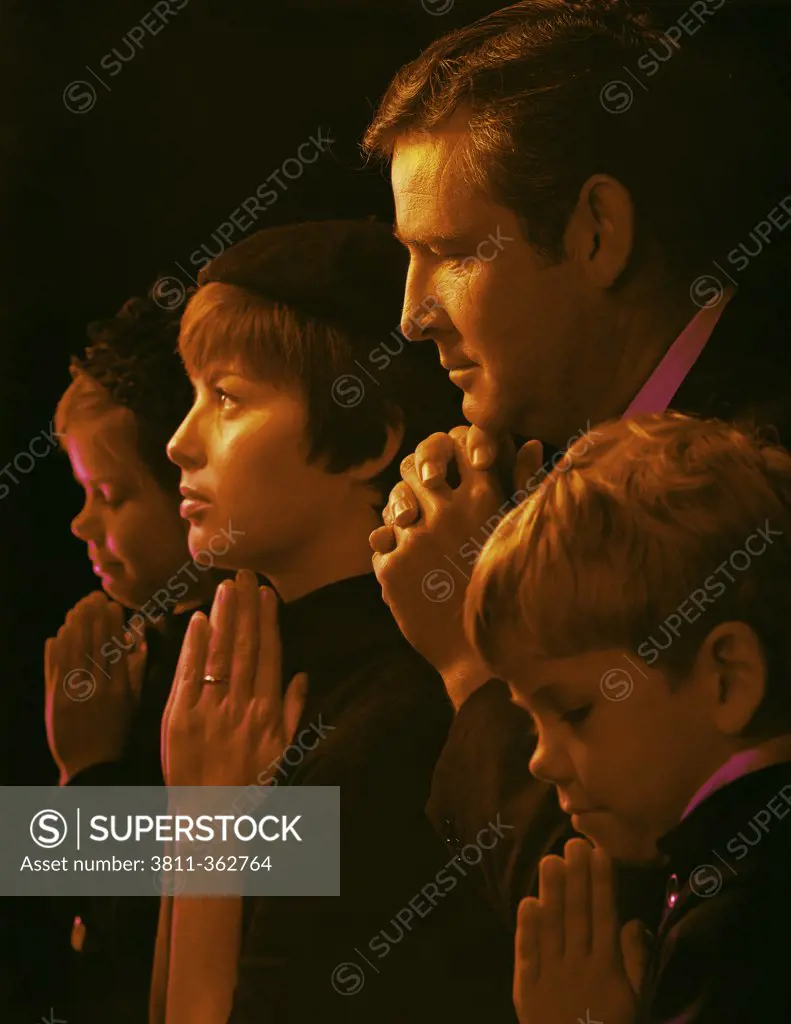 Family praying in a church