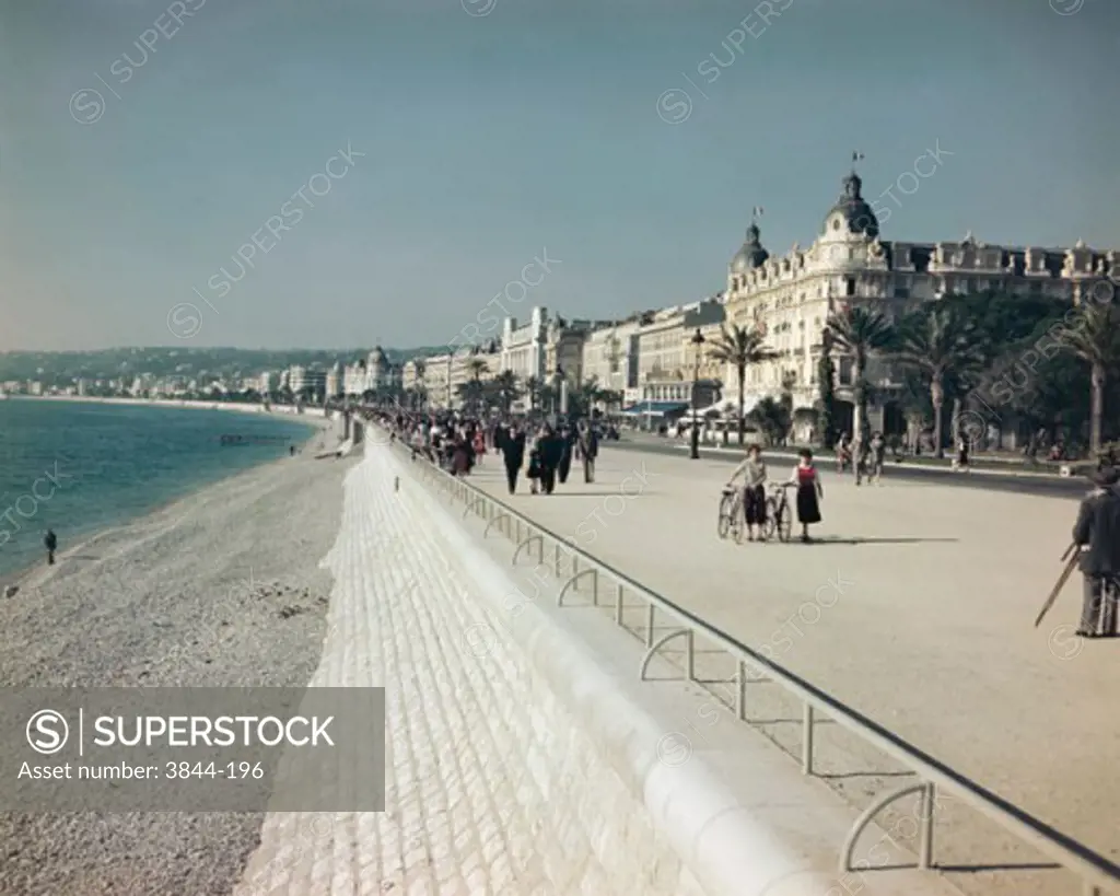 Group of people walking on a pedestrian walkway, French Riviera, Nice, France