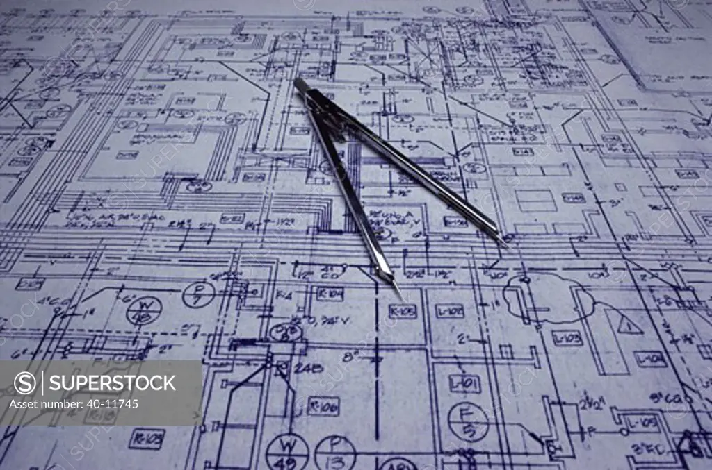 Close-up of a drawing compass on a blueprint