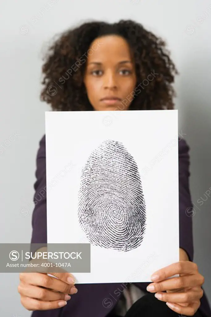 Businesswoman holding up a fingerprint paper