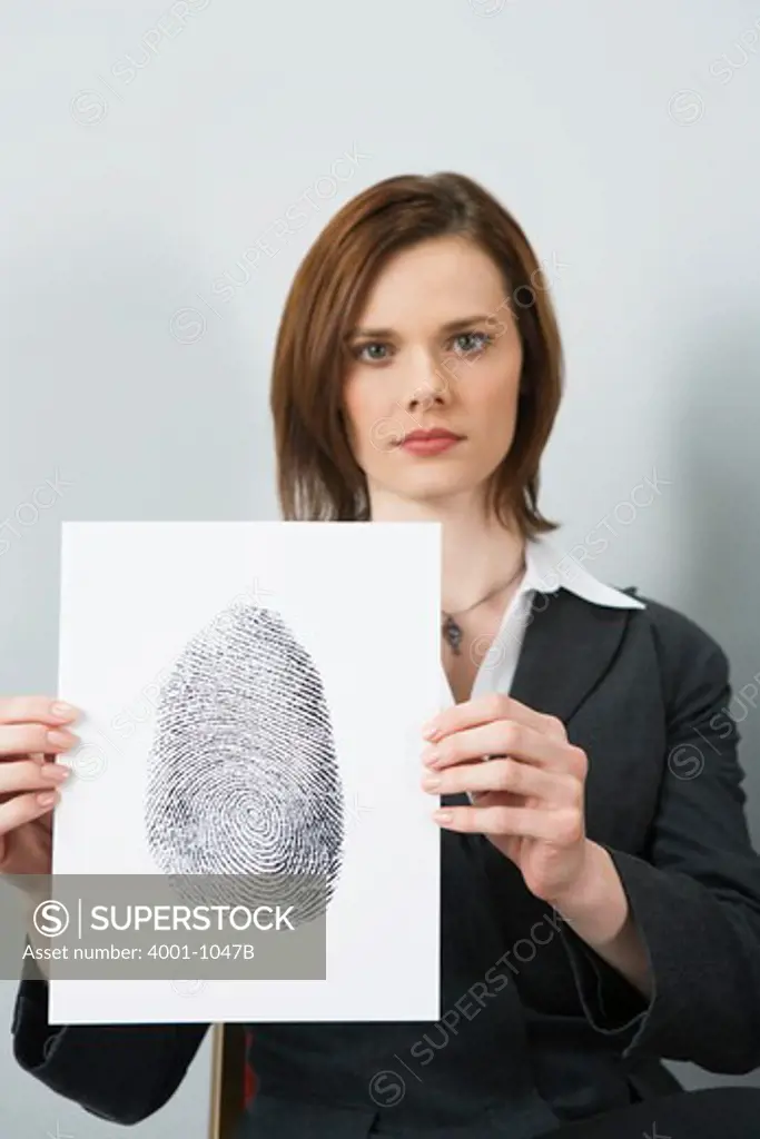 Businesswoman holding a fingerprint paper