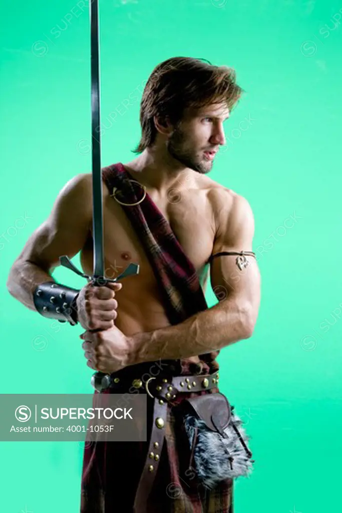 Young man in warrior costume holding a sword