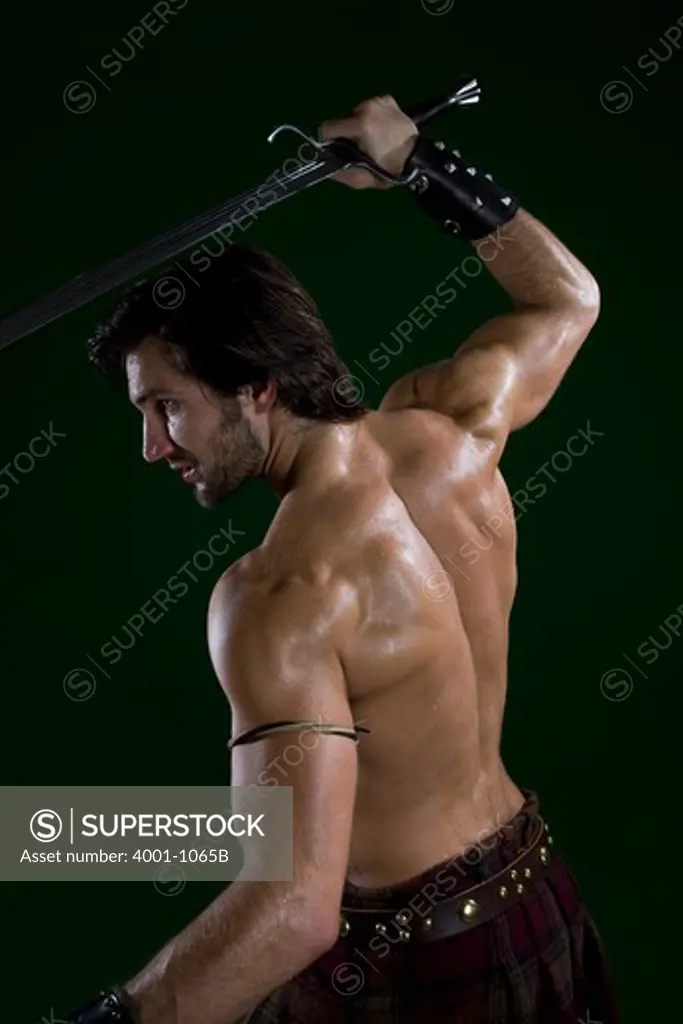 Young man in warrior costume holding a sword