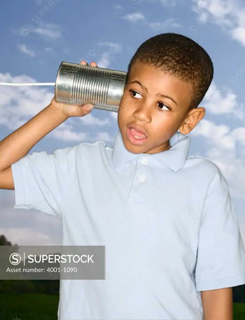 Boy playing with a tin can phone