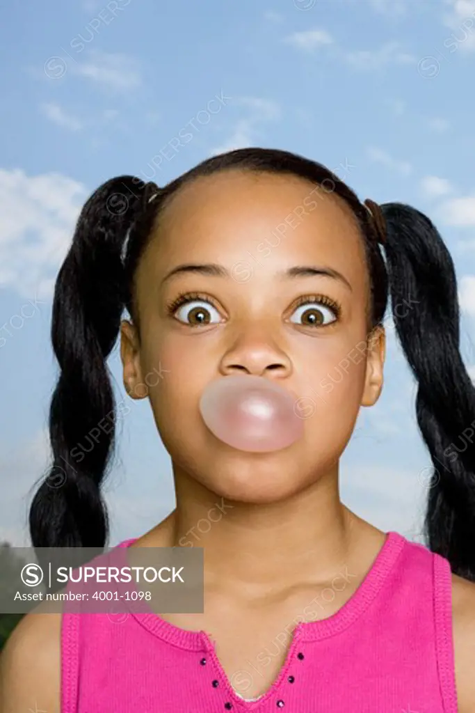 Girl blowing a bubble gum
