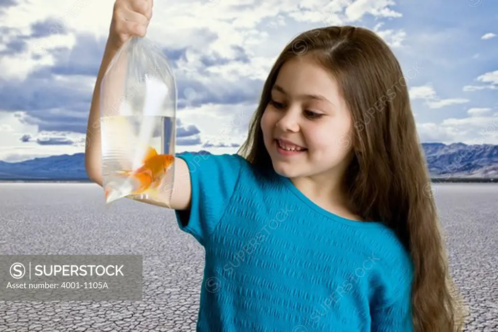Girl watching goldfish in a plastic bag