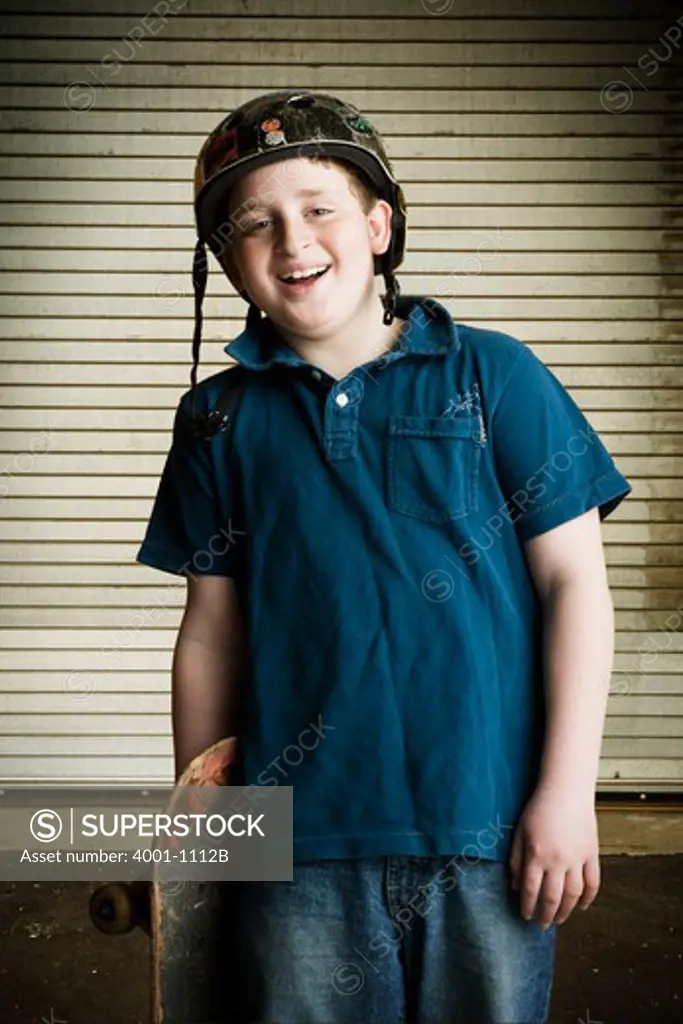 Boy holding a skateboard