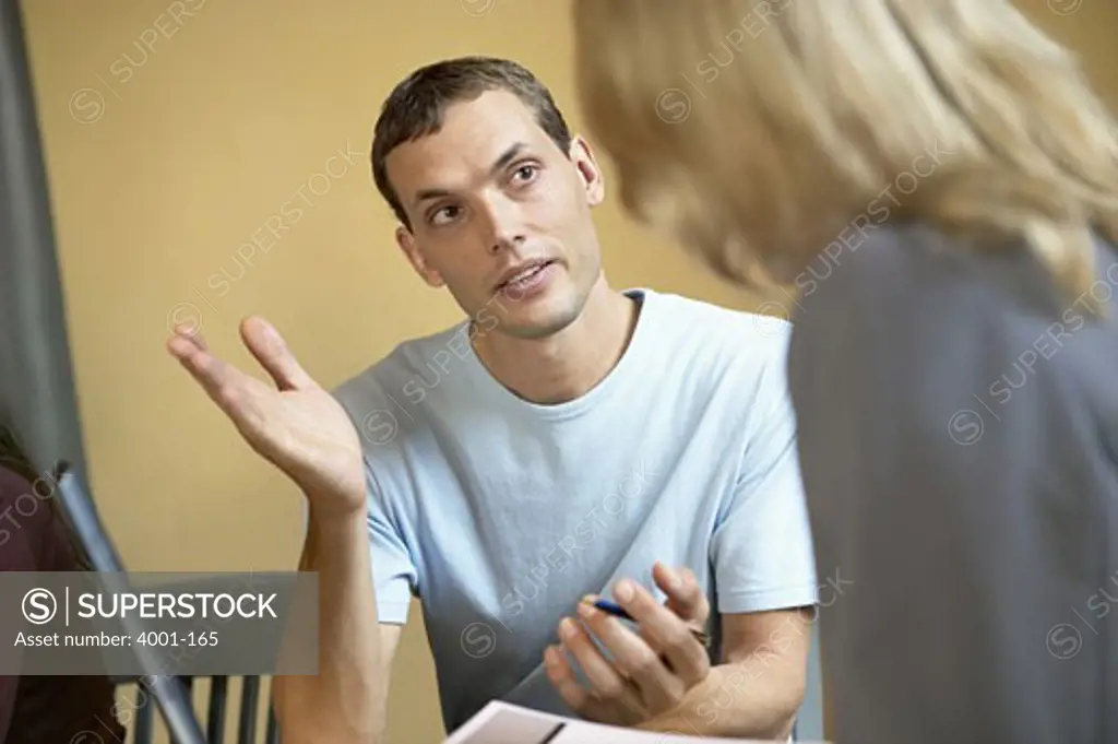 Businessman and a businesswoman discussing in an office