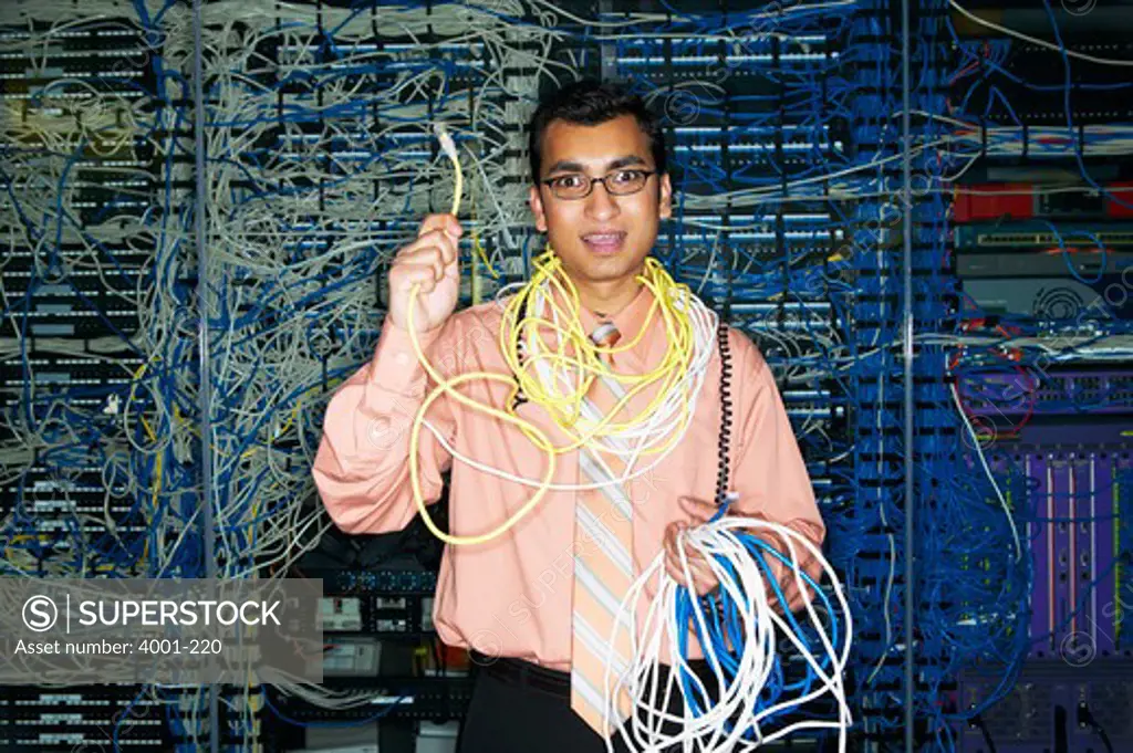 Technician holding tangled computer cables