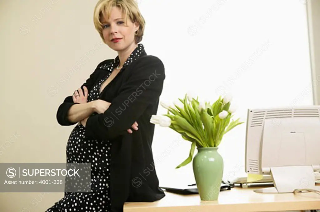 Pregnant woman standing in an office