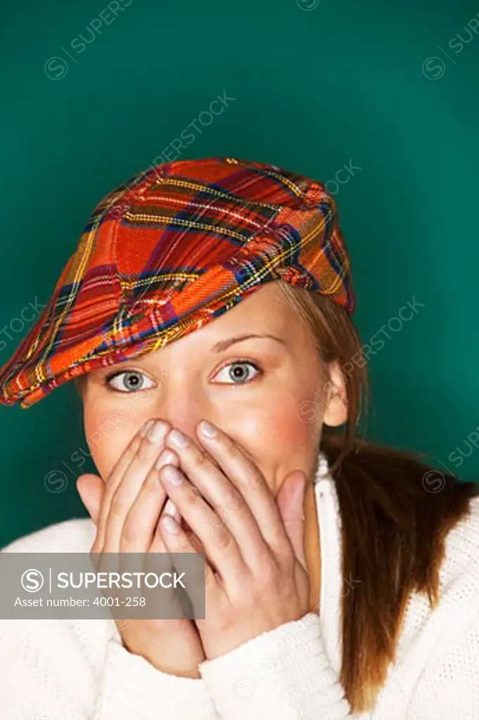 Young woman covering her mouth with hands