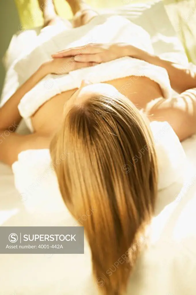 Young woman lying on a massage table