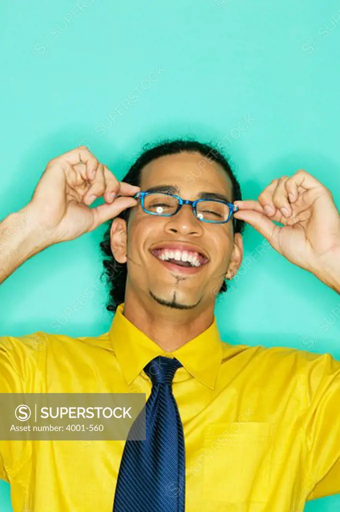 Businessman adjusting his eyeglasses