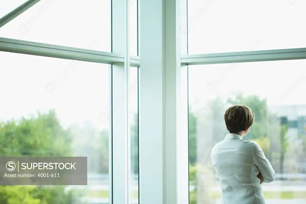 Businesswoman looking through a window