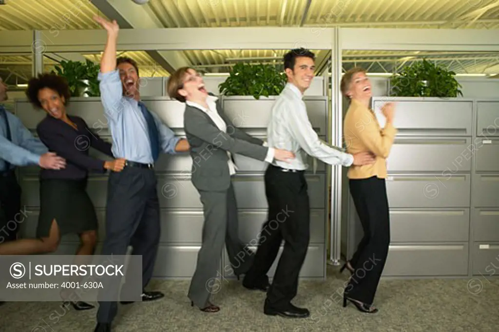 Office workers doing the Conga dancing