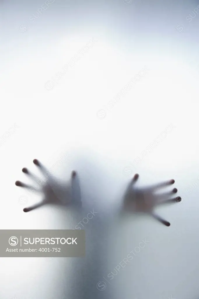 Person's hands touching a frosted glass