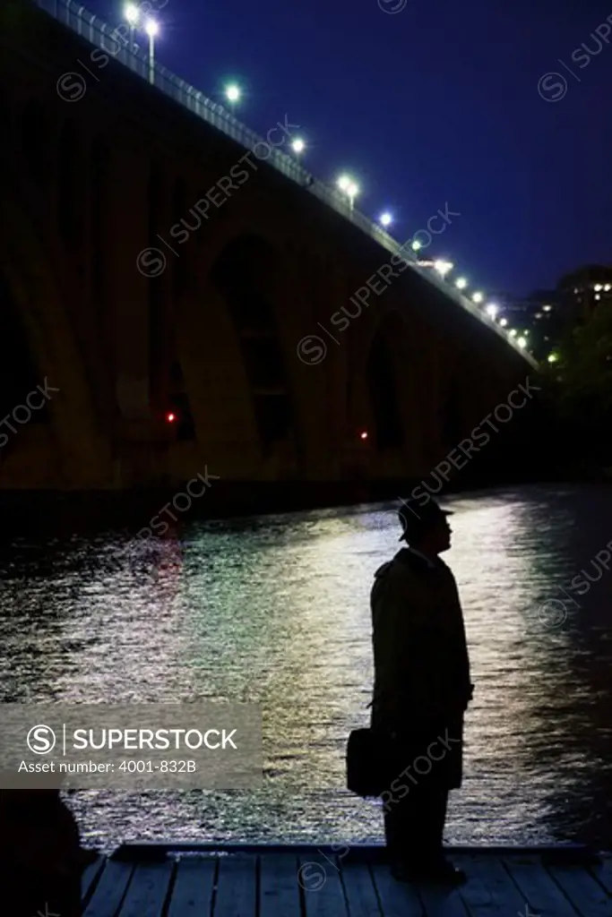 Silhouette of a spy standing at the riverside, Washington DC, USA