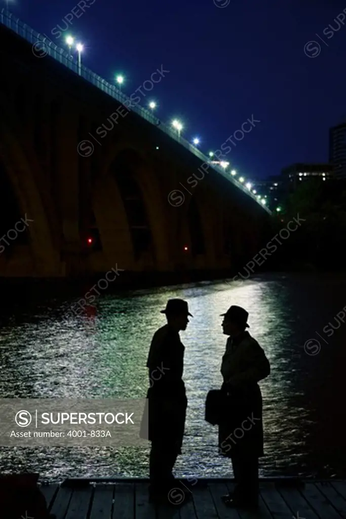 Two spies discussing at the riverside, Washington DC, USA