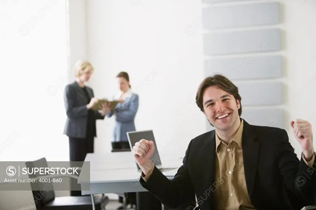 Businessman cheering in an office