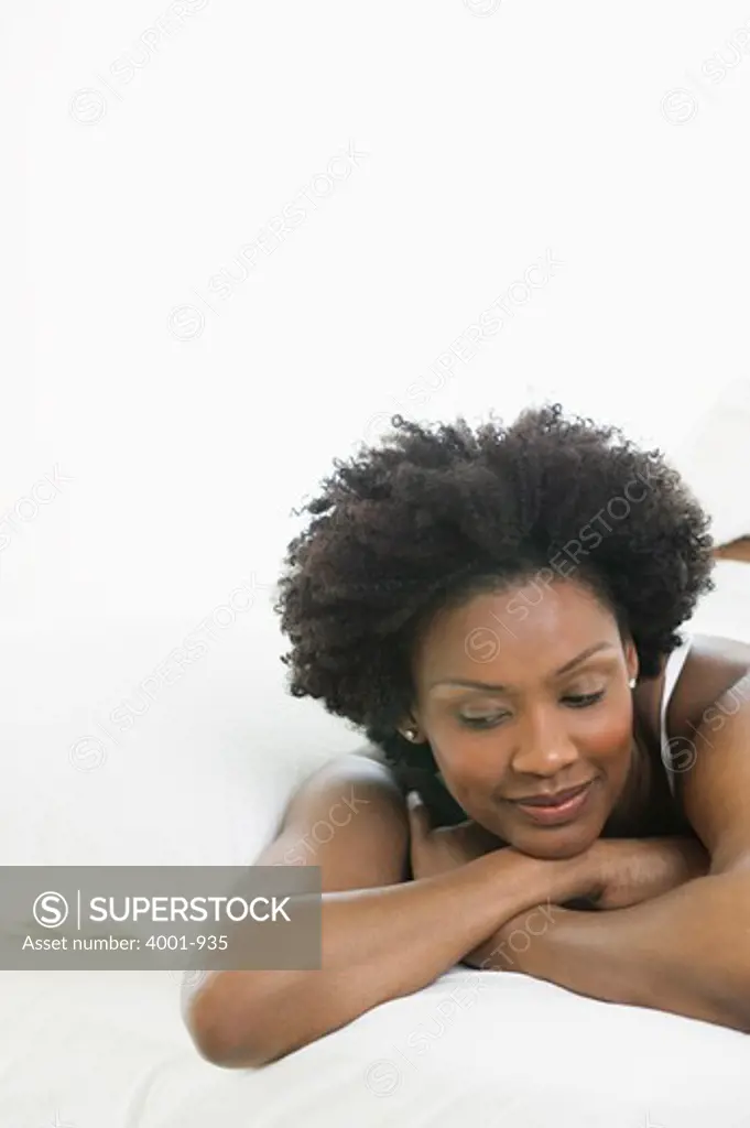 Close-up of a young woman day dreaming on the bed