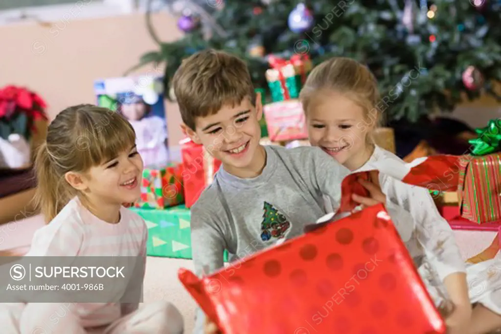 Children opening Christmas present