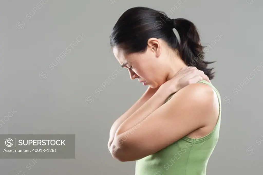 Side profile of a young woman suffering from neckache