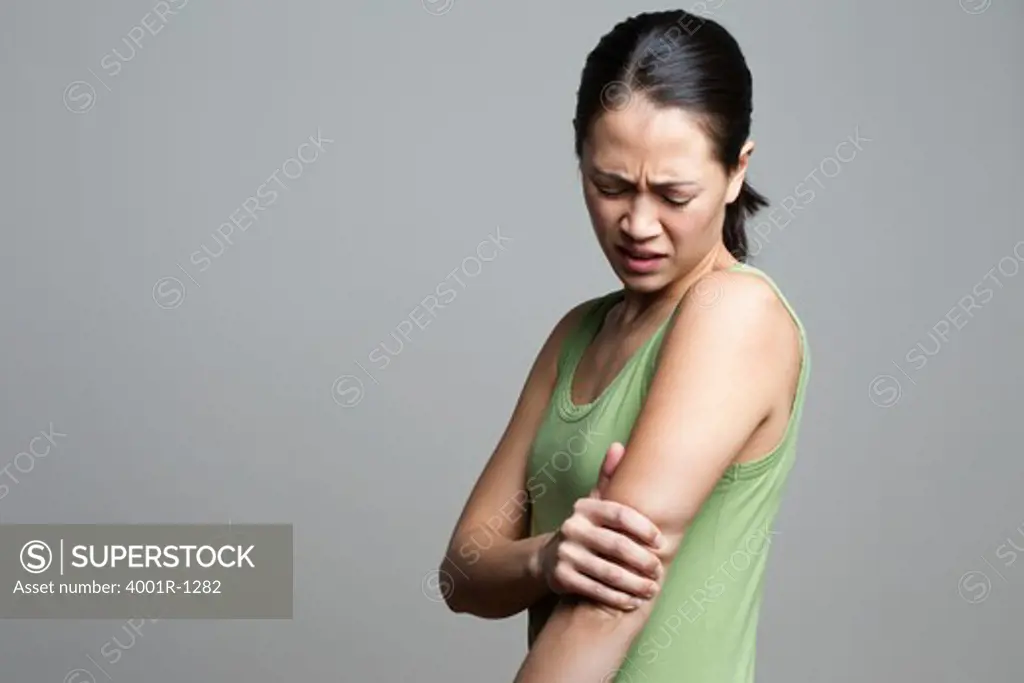Young woman suffering from elbow pain