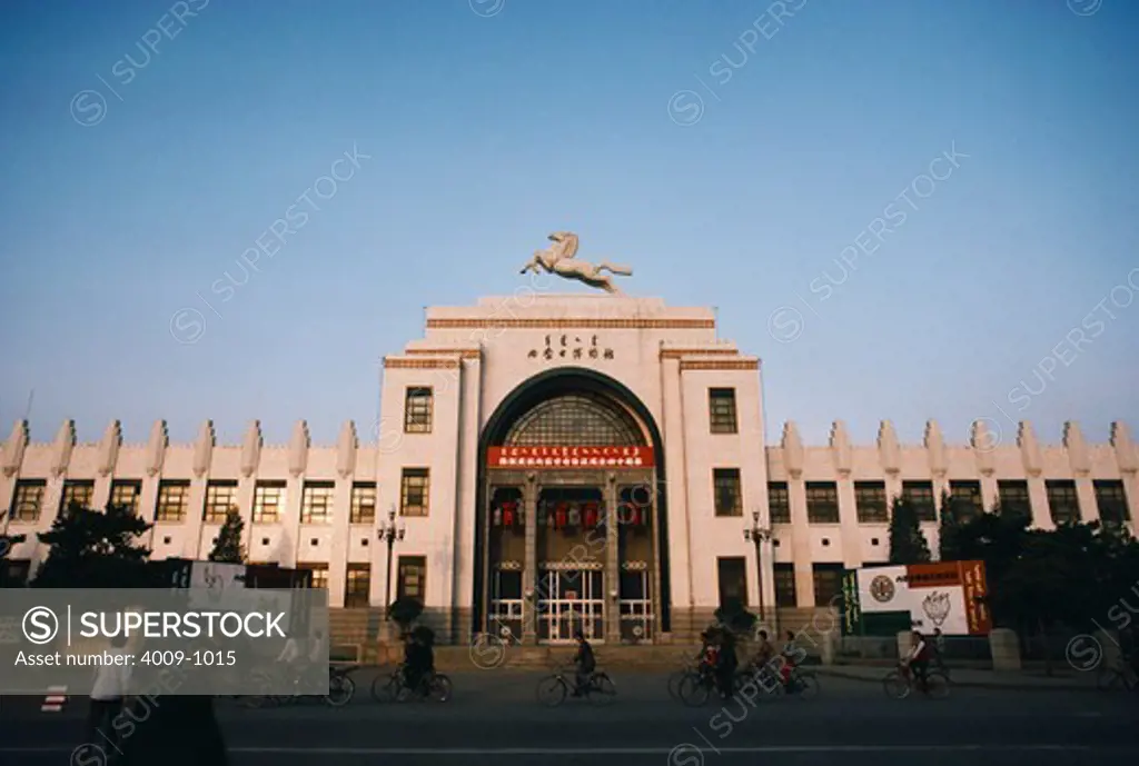 People commuting in front a museum, Inner Mongolia Museum, Hohhot, Inner Mongolia, China