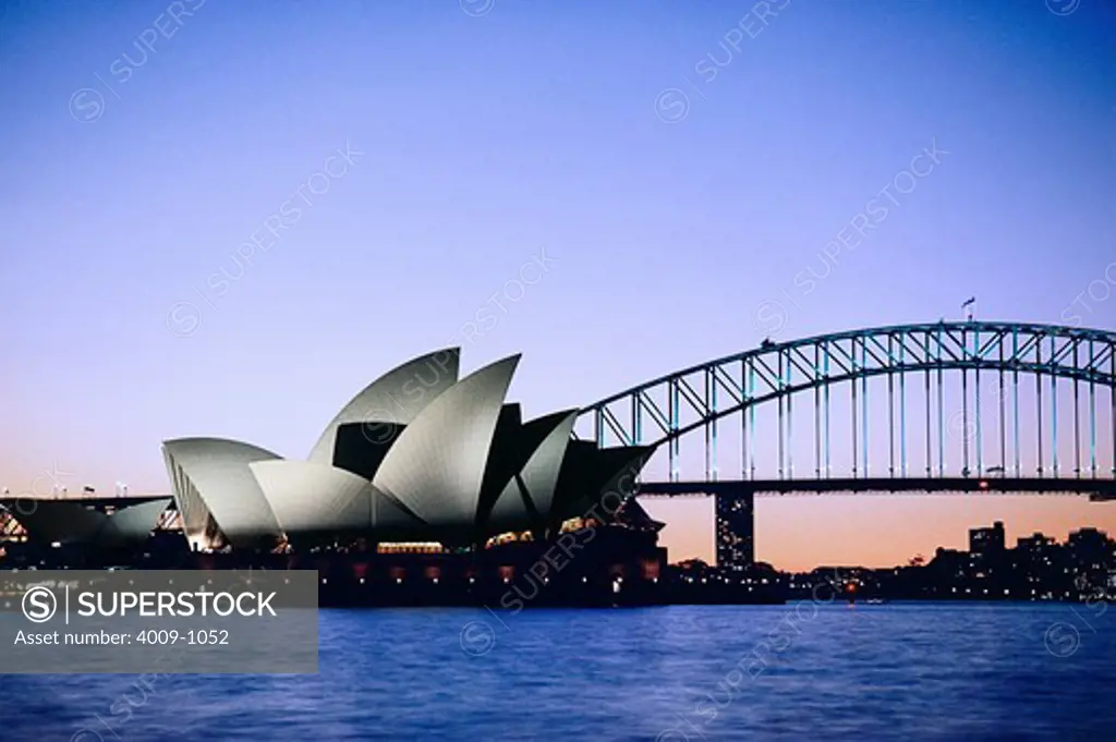 Opera house in front of a bridge, Sydney Opera House, Sydney Harbor Bridge, Sydney, New South Wales, Australia