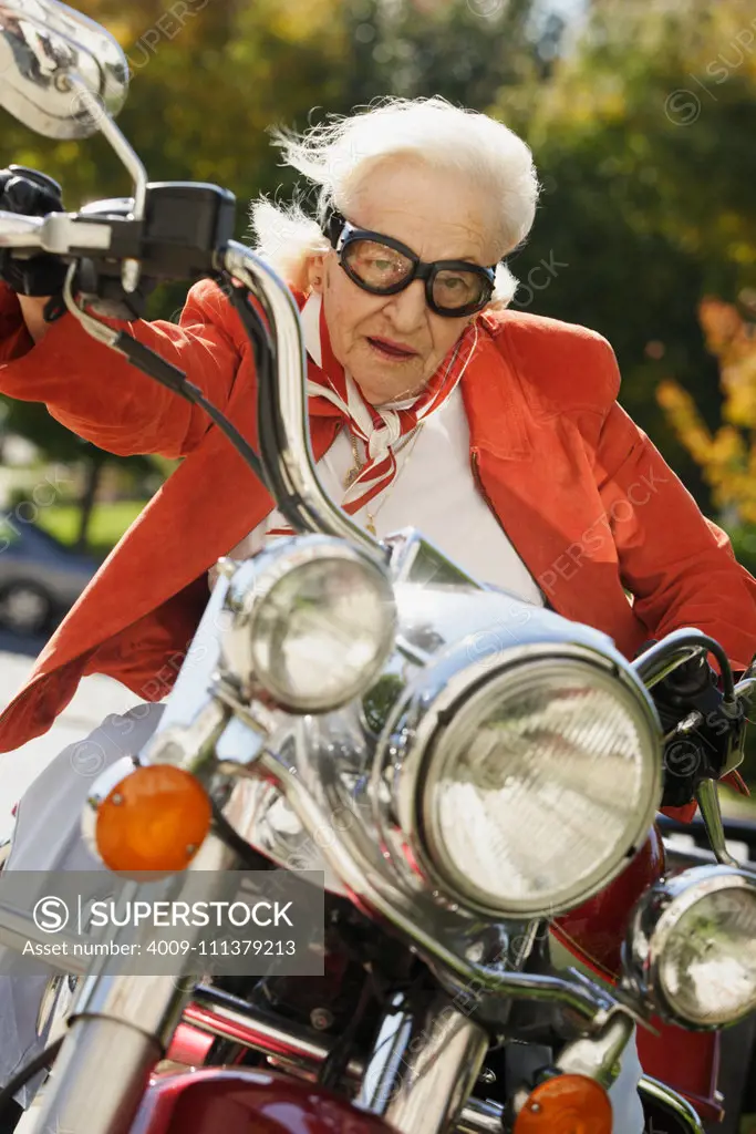 Elderly woman driving a motorcycle