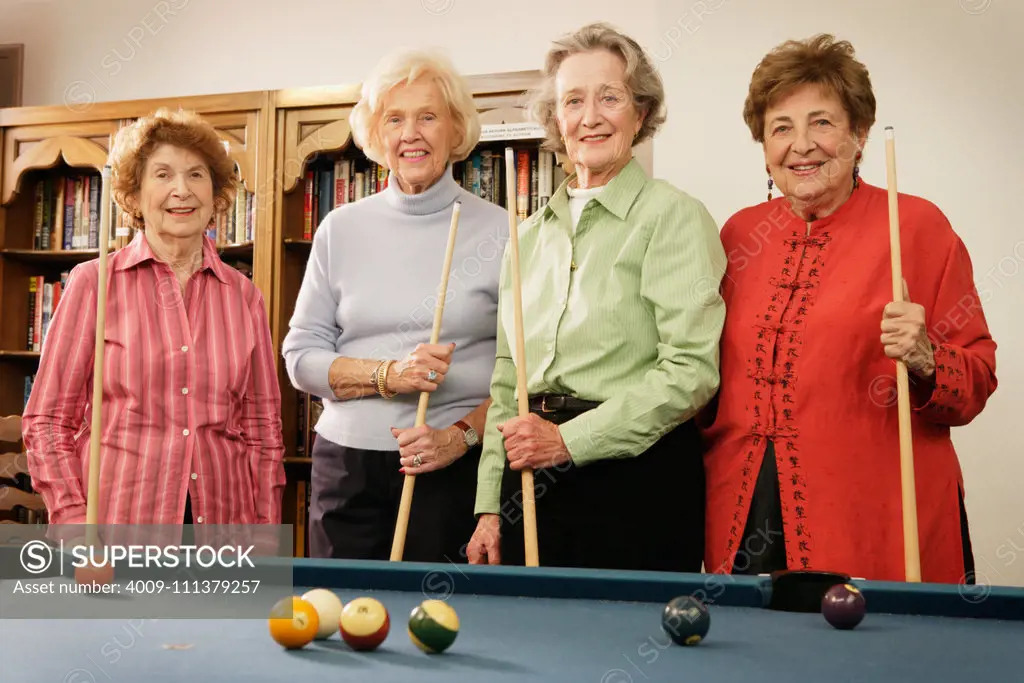 Elderly women shooting pool