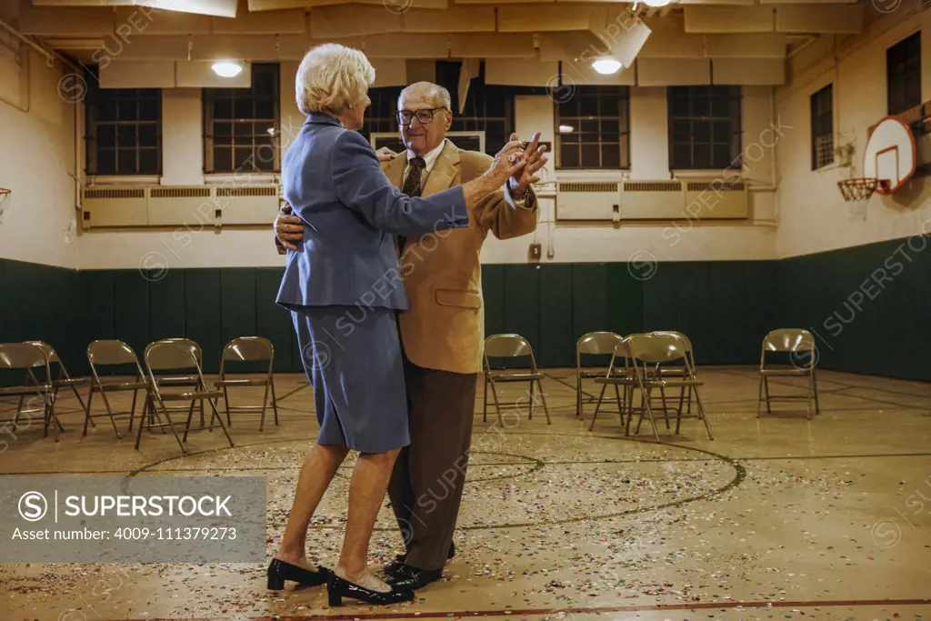 Elderly couple dancing in a gym