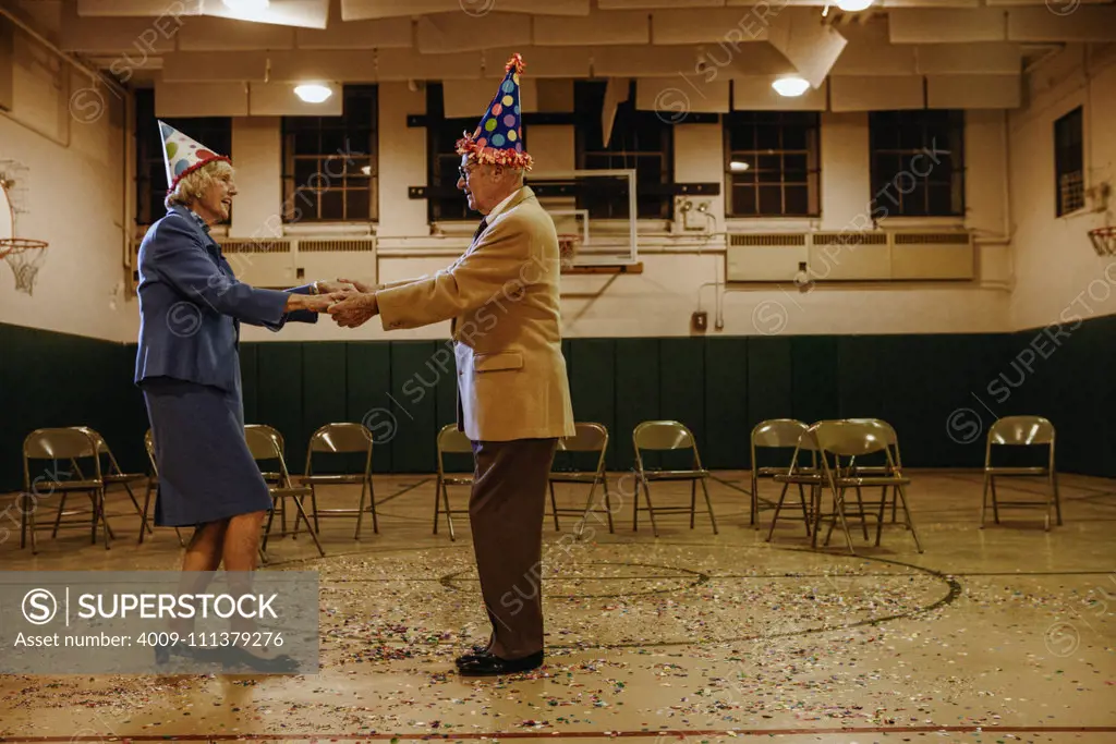 Elderly couple dancing in a gym