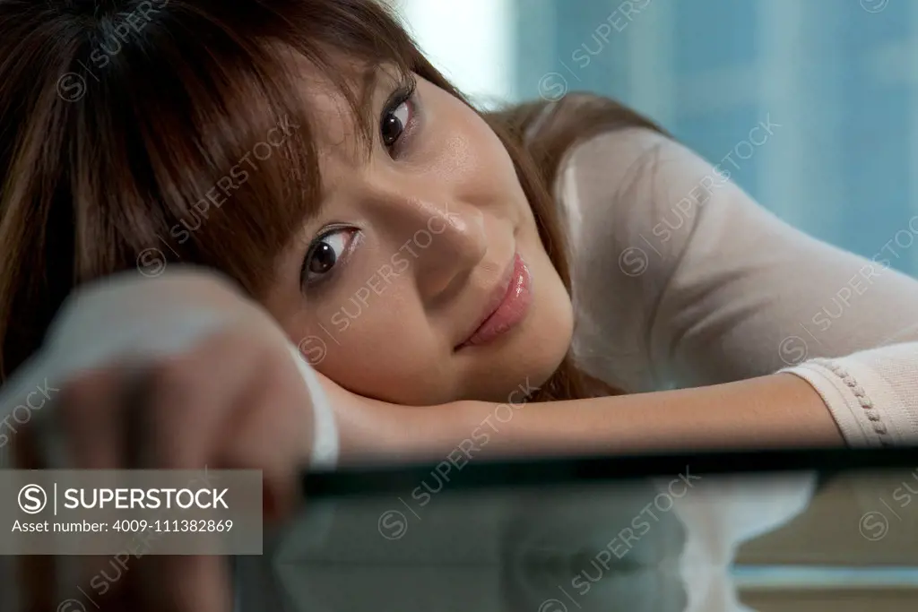 Woman leaning on table