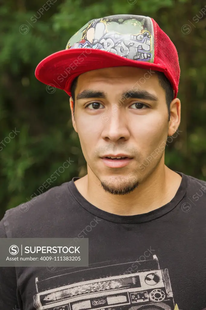 Serious Hispanic man in baseball cap