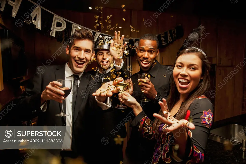 Friends drinking in kitchen at New Year's Eve party