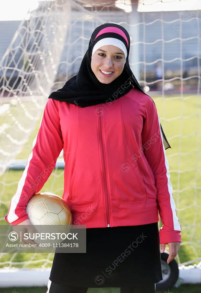 Muslim teenager holding soccer ball