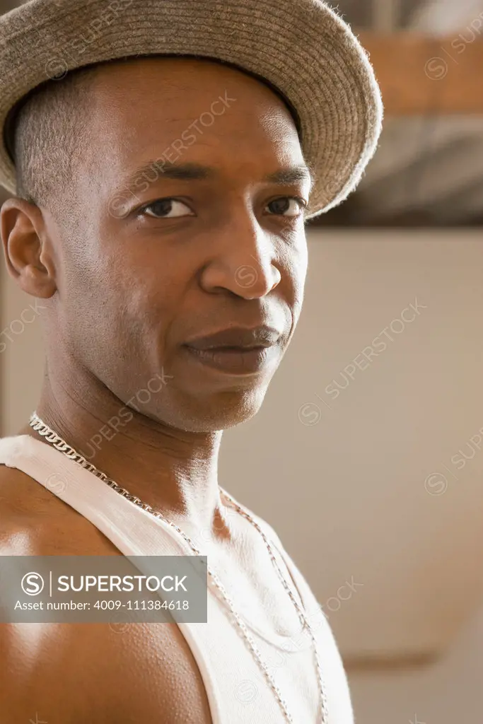 Mixed race man in hat and tank top