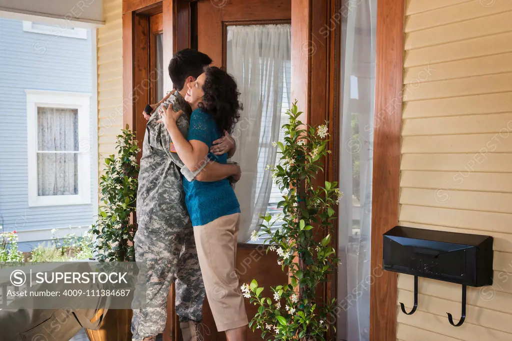 Hispanic mother greeting soldier son