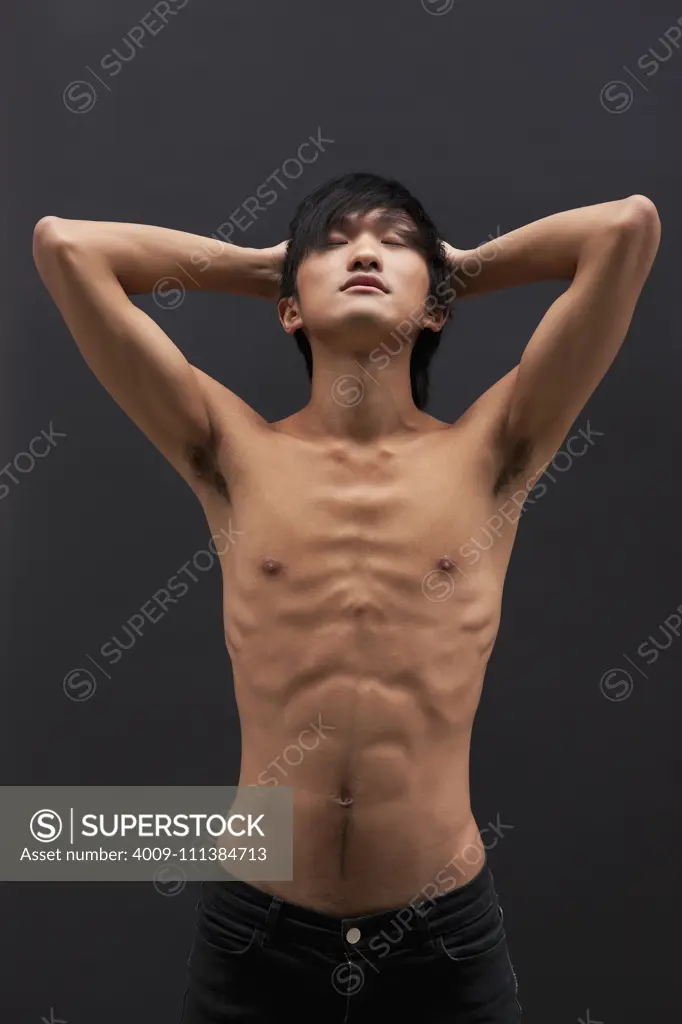 Shirtless Asian man posing