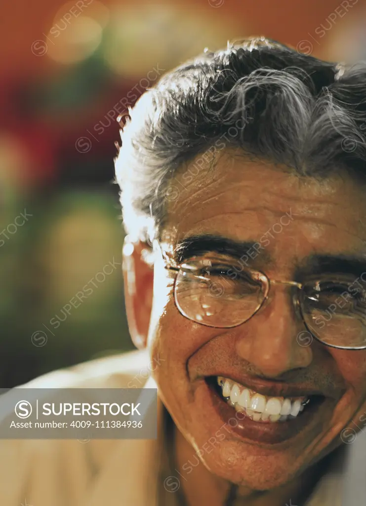 Senior man in eyeglasses laughing