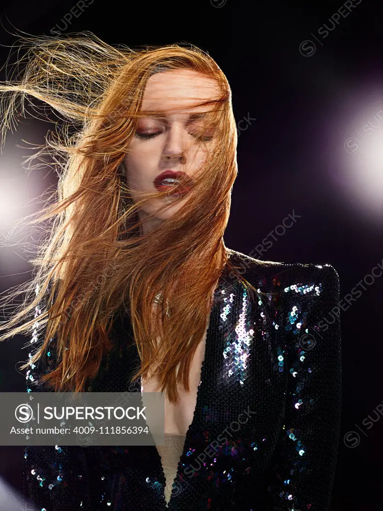 Portrait of a woman with light flares and wind