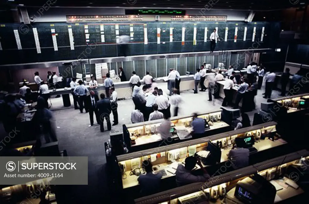 Traders working in the open floor of a stock trading center, Sydney, New South Wales, Australia