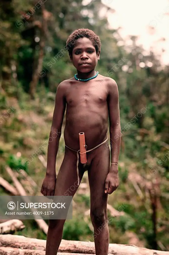 Indonesian boy standing in a forest Irian Jaya, New Guinea, Indonesia
