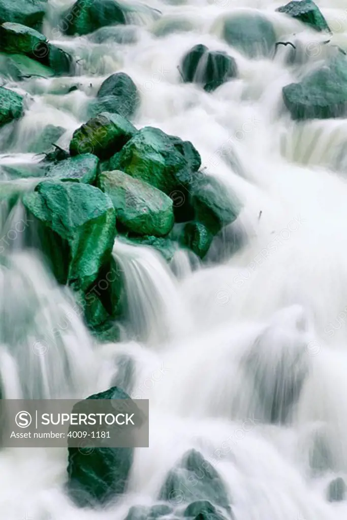Water rushing over green rocks, Irian Jaya, New Guinea, Indonesia