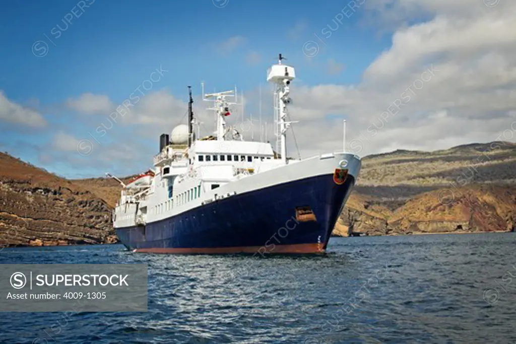Ecuador, Galapagos Islands, Ship sailing in ocean near mountains